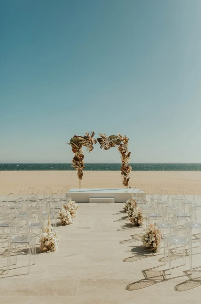 Beachfront wedding ceremony at sunset